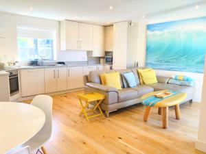 a living room with a couch and a table at Sandpiper Cottages in Newquay
