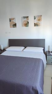 Ένα ή περισσότερα κρεβάτια σε δωμάτιο στο PaMa House comfort e relax a due passi dal centro +19 φωτογραφίες