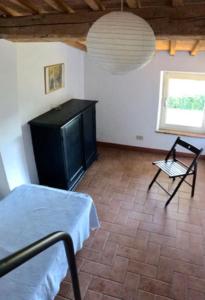 a room with a bed and a table and a chair at La Casa Rossa in Marina di Bibbona