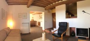 a living room with a couch and a chair at La Casa Rossa 2 in Marina di Bibbona