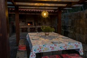 a table with a table cloth on it in a room at Barrocal Nature Houses in Nelas