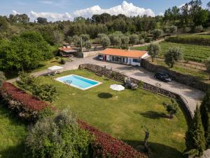 an aerial view of a villa with a swimming pool at Barrocal Nature Houses in Nelas