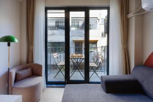 a living room with a sliding glass door with a balcony at by Abraham Galata in Istanbul