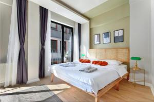 a bedroom with a bed with orange pillows on it at by Abraham Galata in Istanbul