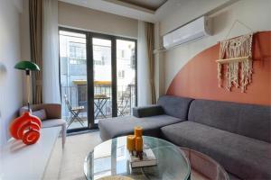 a living room with a couch and a glass table at by Abraham Galata in Istanbul