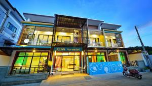 a building with a scooter parked in front of it at Kiss Hometel in Ao Nang Beach