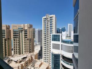a view of a city skyline with tall buildings at Aspire Tower-Two Bedroom Palm Stay in Manama