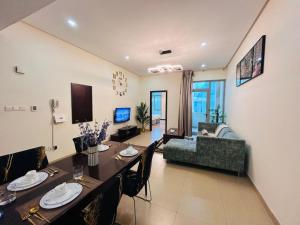 a living room with a dining table and a couch at Aspire Tower - One Bedroom Solo Haven Juffair in Manama