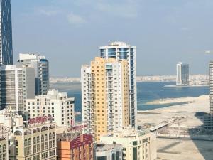 an aerial view of a city with tall buildings at Aspire Tower - One Bedroom Solo Haven Juffair in Manama
