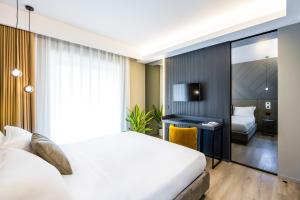 MH SUITES Plebiscito客房内的一张或多张床位