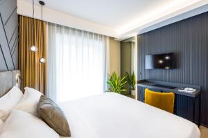 MH SUITES Plebiscito客房内的一张或多张床位