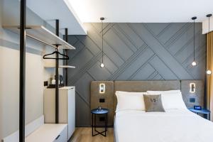 MH SUITES Plebiscito客房内的一张或多张床位