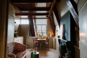 a living room with a couch and a table at Molen den Bonk in Lexmond