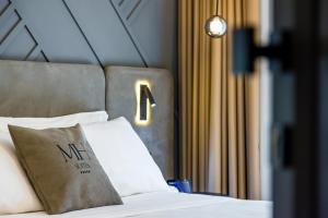 MH SUITES Plebiscito客房内的一张或多张床位