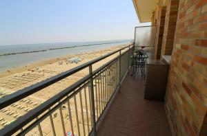 a balcony with a view of the beach at 14 Trilocale fronte mare Evangelisti Casa in Bellaria-Igea Marina