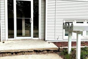 a house with a door and a mailbox in front of it at Economy 3 beds in Moorhead