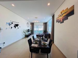 a dining room with a table and some chairs at Aspire TowerTwo Bedroom Pilot Paradise in Manama