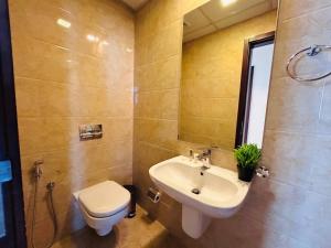 a bathroom with a sink and a toilet at Aspire TowerTwo Bedroom Pilot Paradise in Manama +13 photos