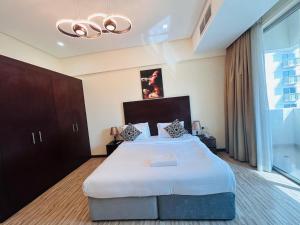 a bedroom with a large bed and a large window at Aspire Tower-Two Bedroom Urban Haven Juffair in Manama +11 photos