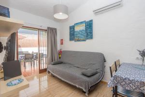 a room with a bed and a table and a table and a table at Private Chill-out Terrace Bungalow - Pool in San Bartolomé de Tirajana