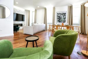 a living room with green chairs and a couch at Green Essence Duplex in Faro by Misha's Place in Faro