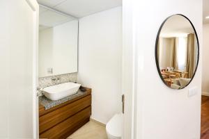a bathroom with a mirror and a sink at Green Essence Duplex in Faro by Misha's Place in Faro +12 photos