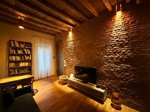 a living room with a brick wall and a fireplace at Emme Loft I First Moon - Exclusive Design Apartment with balcony in Milan