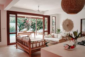a living room with a couch and a table at Eden Escapes - Diani Beach, Kenya in Diani Beach