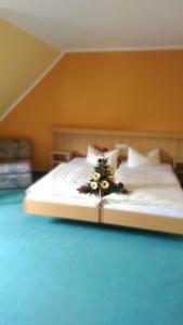 a bedroom with a bed with a christmas tree on it at Hotel & Restaurant Zur Weintraube in Jena +37 photos