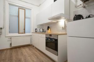 维也纳Amazing 2BR Shared Apt Only 7 Min to Wiener Stadthalle的配有白色橱柜和冰箱的厨房