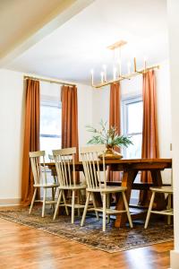 a dining room with a wooden table and chairs at The Bidwell Bungalow in Amanda