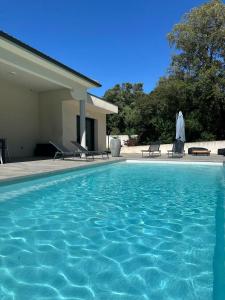 a swimming pool in front of a house at VILLA BENOA in Oletta +8 photos