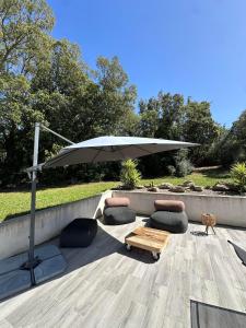 a patio with an umbrella and chairs and a table at VILLA BENOA in Oletta