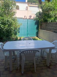 a blue table and chairs on a patio at Slyre in Cap d'Agde