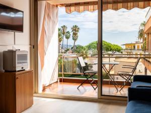 a living room with a view of a balcony at Apartment AcquadiMare by Interhome in Sanremo