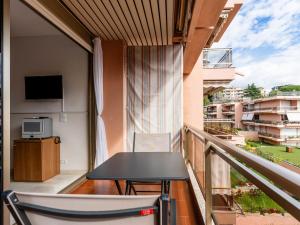a balcony with a table and a tv on a balcony at Apartment AcquadiMare by Interhome in Sanremo