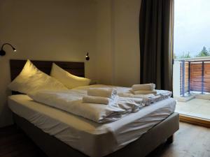 a bed with white sheets and pillows in a bedroom at Apartment Home Holzwurm by Interhome in See