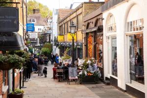 a city street with people walking down a street at Pass the Keys Elegant flat in trendy Hampstead in London