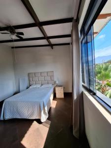 a bedroom with a bed and a large window at Acogedor Apartamento en Tarapoto in Tarapoto
