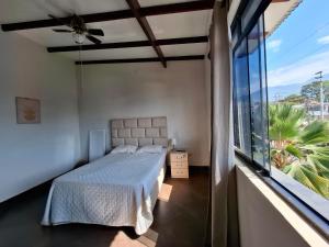 a bedroom with a bed and a large window at Acogedor Apartamento en Tarapoto in Tarapoto