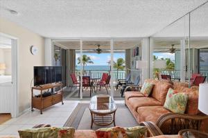 a living room with a couch and a television at Oceanfront Oasis in Key West