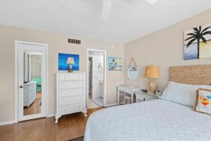 a bedroom with a bed and a desk and a bedroom at Oceanfront Oasis in Key West +23 photos