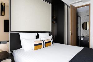 a bedroom with a large bed with white pillows at HIGHSTAY - Luxury Serviced Apartments - North Marais 2 in Paris