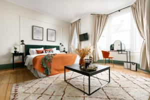 a bedroom with a bed and a coffee table at NEW LUXURY for 2024 - Central Plymouth House - Sleeps 10 - Access to Plymouth Town - Close to The Barbican - Pets welcome - Parking Available - By Luxe Living by Sophia in Plymouth