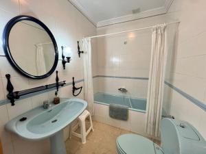 a bathroom with a sink and a toilet and a mirror at Sergio Village, a 200mt del Mar! in Isla Plana