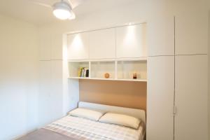 a small room with a closet and a bed at La casa di Bella - con Piscina in Padenghe sul Garda +17 photos
