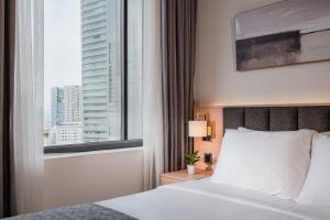 En eller flere senge i et værelse på Keypad Hotel - Linh Lang