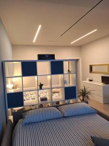 a bedroom with a bed with a blue and white headboard at Al Ventisei - Azzurro in Treiso