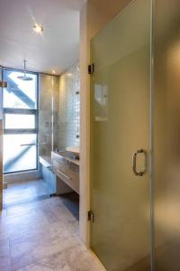 a bathroom with a shower and a glass door at Penthouse nuevo con terraza en zona centro historico in Puebla