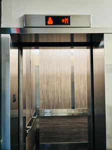 an elevator door with a sign on top of it at 6th Floor 2 Bedroom Condo with Parking in Calgary